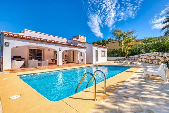 a swimming pool in the backyard of a house at Casa Las Lunas Javea in El Tosalet