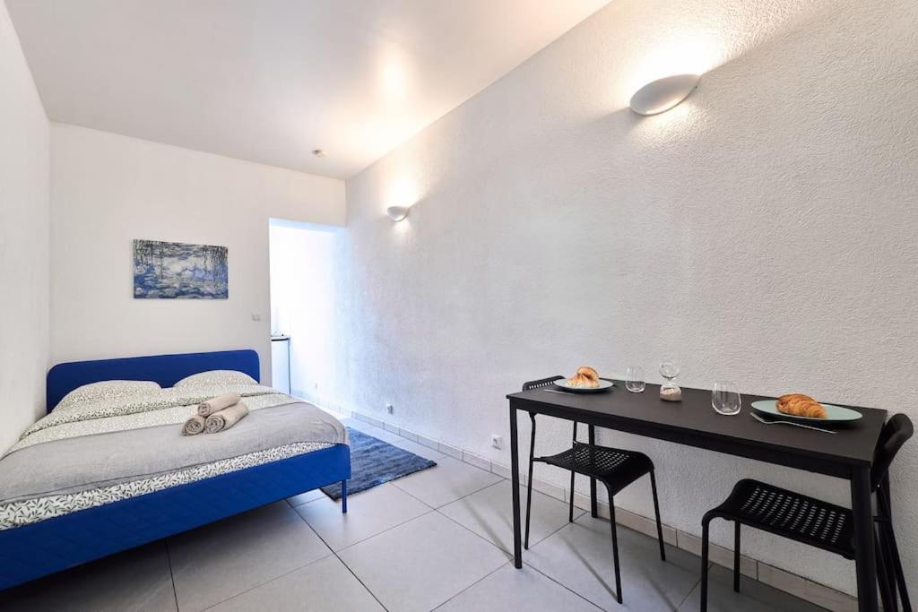- une chambre avec un lit et une table avec de la nourriture dans l'établissement Le Petit Marceaux - T1 - Confort, à Reims