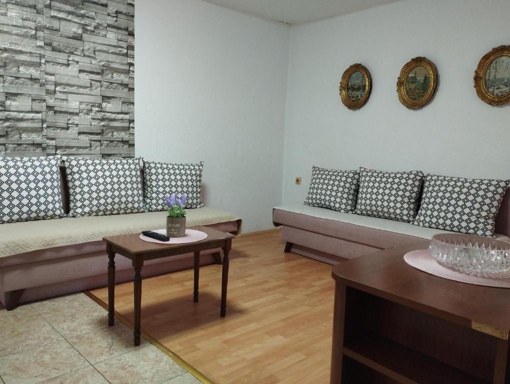 a living room with couches and a table in a room at Vila Katerina Dojran in Sretenovo