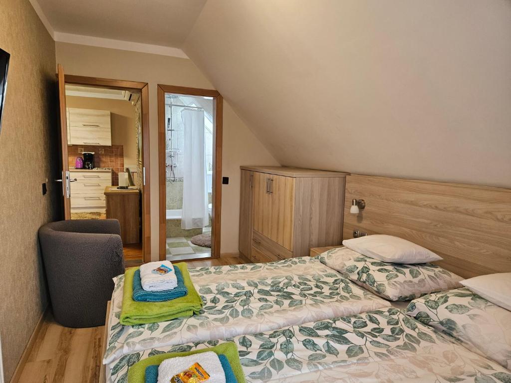 A bed or beds in a room at Apartman Siesta Bük - Bükfürdő
