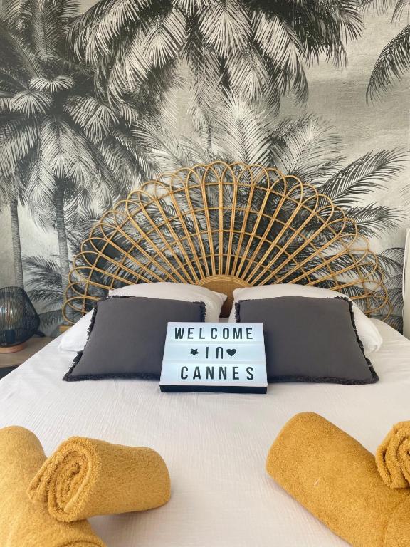 - un lit avec un panneau de jeux de bienvenue dans l'établissement Studio Stella, à Cannes
