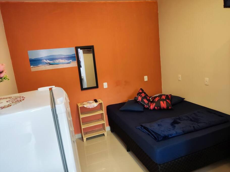 a bedroom with a bed and a mirror and a ladder at Loft 03 c ar condicionado proximo praias e Expocenter BC in Balneário Camboriú