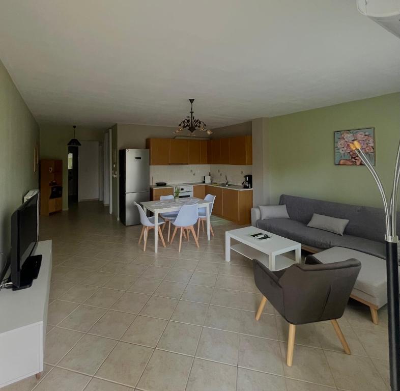 a living room and kitchen with a couch and a table at Family House Dim in Ioannina