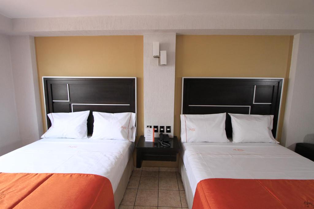 Postel nebo postele na pokoji v ubytování Hotel Estadio
