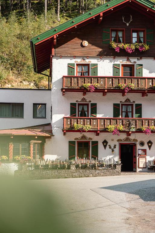 a building with a balcony with flowers on it at Schallerhof in Neustift im Stubaital