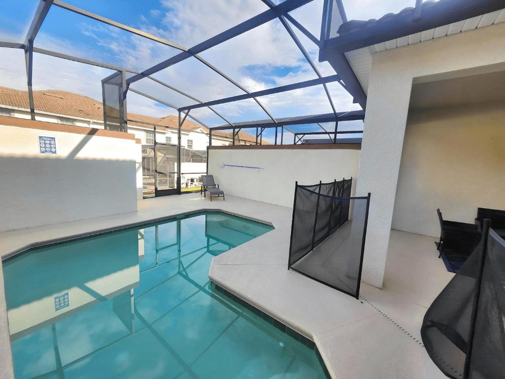 an indoor swimming pool with a glass roof at 4BD/3BA Champions Gate Home With Private Pool in Davenport