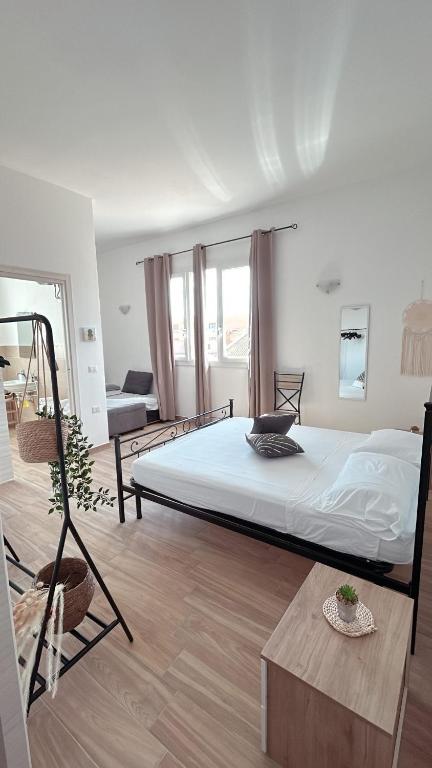 a bedroom with a large bed in a room at Marina Casa Vacanza in Capoterra