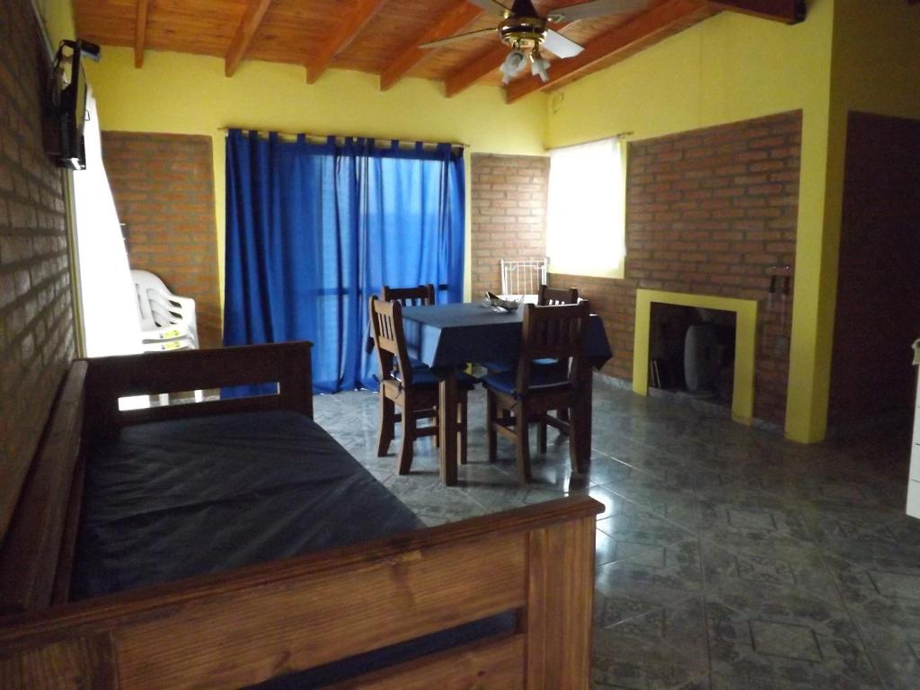 a dining room with a table and a table and chairs at Cabañas San Jose in Potrero de Garay