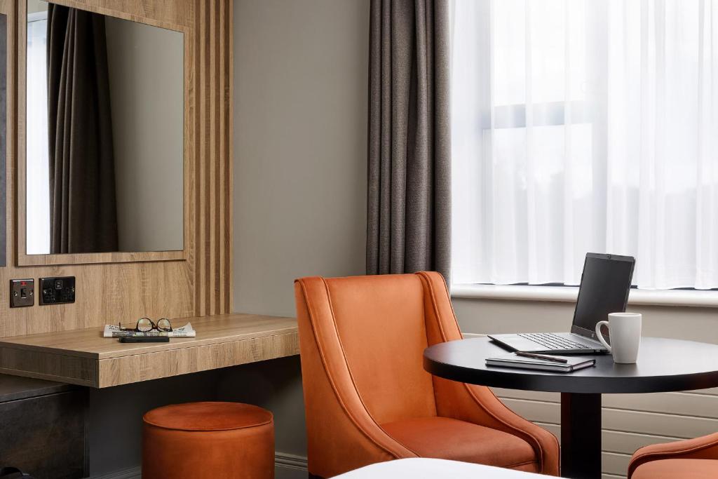 a hotel room with a table with a laptop on it at Springfield Hotel in Leixlip