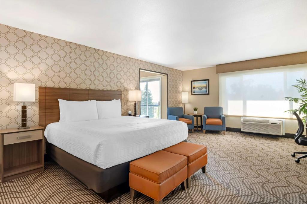 a hotel room with a bed and a large window at Best Western Plus Heritage Inn in Benicia