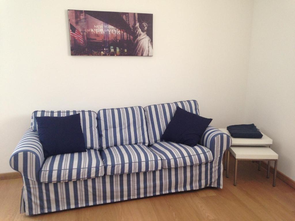 a blue and white couch in a living room at La Supernova in Bergamo