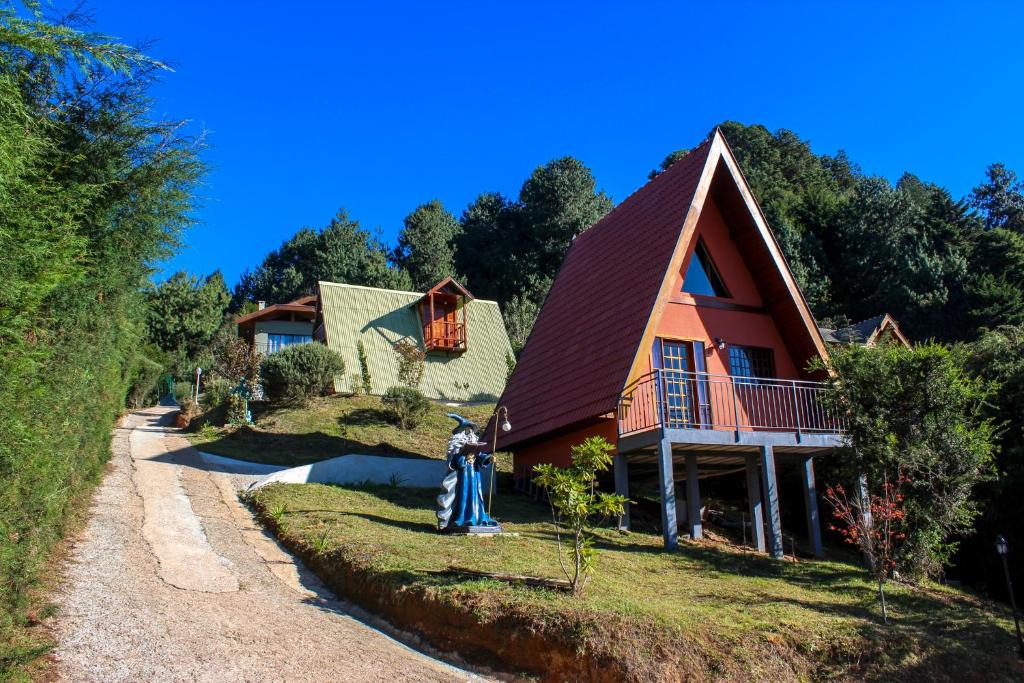 a house on the side of a hill at Recanto do Bosque in Campos do Jordão