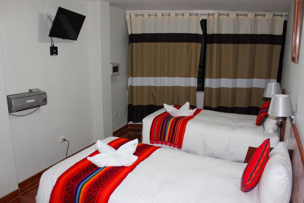 Postel nebo postele na pokoji v ubytování Hotel Wiracocha Machupicchu
