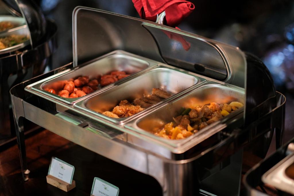 a buffet with many trays of food at Trang An Ecolodge in Ninh Binh