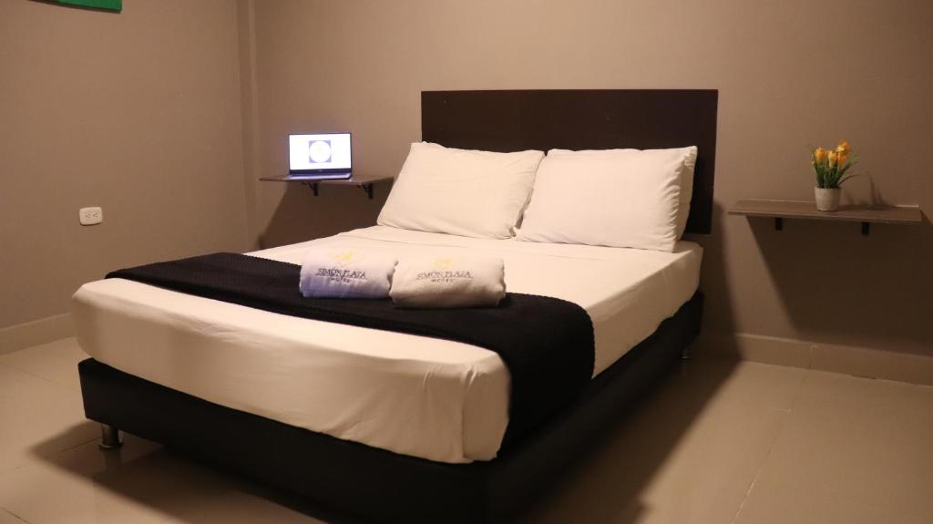 Postel nebo postele na pokoji v ubytování Hotel Simón Plaza