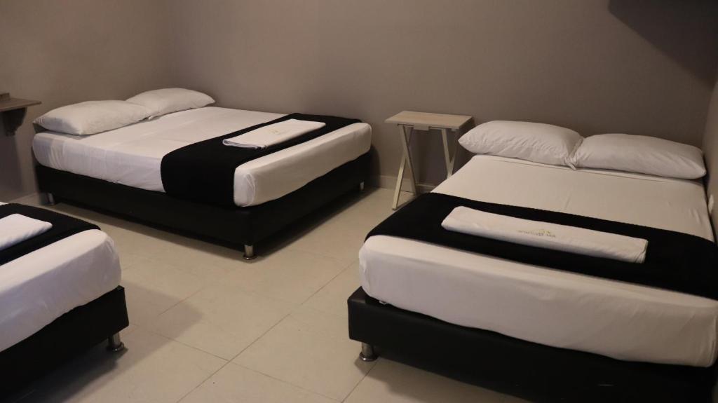 Postel nebo postele na pokoji v ubytování Hotel Simón Plaza