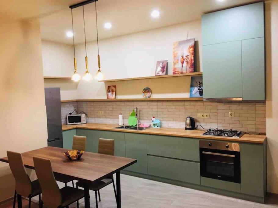 a kitchen with a table and a dining room at Home-Dighomi in Tbilisi City