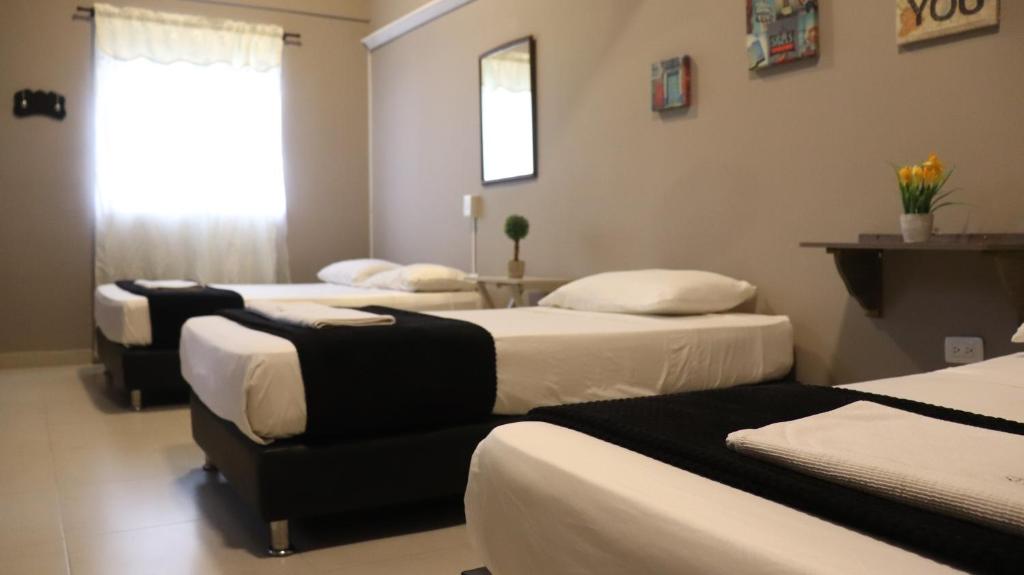 Postel nebo postele na pokoji v ubytování Hotel Simón Plaza