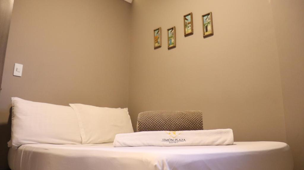 Postel nebo postele na pokoji v ubytování Hotel Simón Plaza