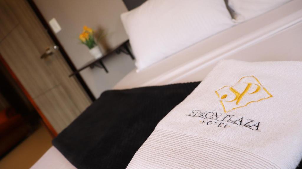 Postel nebo postele na pokoji v ubytování Hotel Simón Plaza