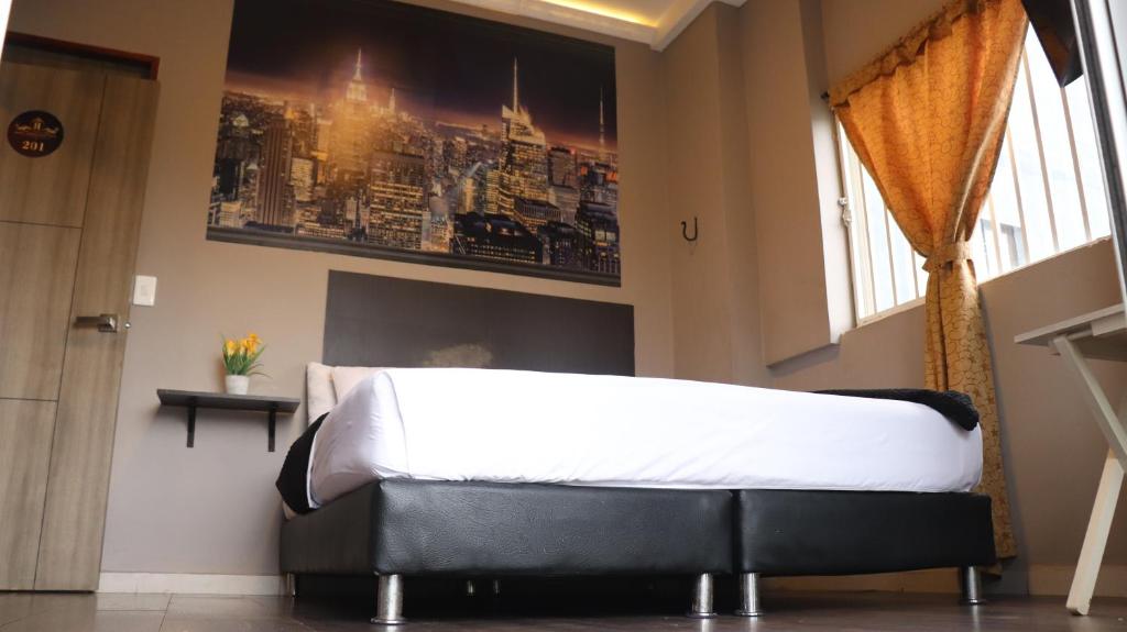 Postel nebo postele na pokoji v ubytování Hotel Simón Plaza
