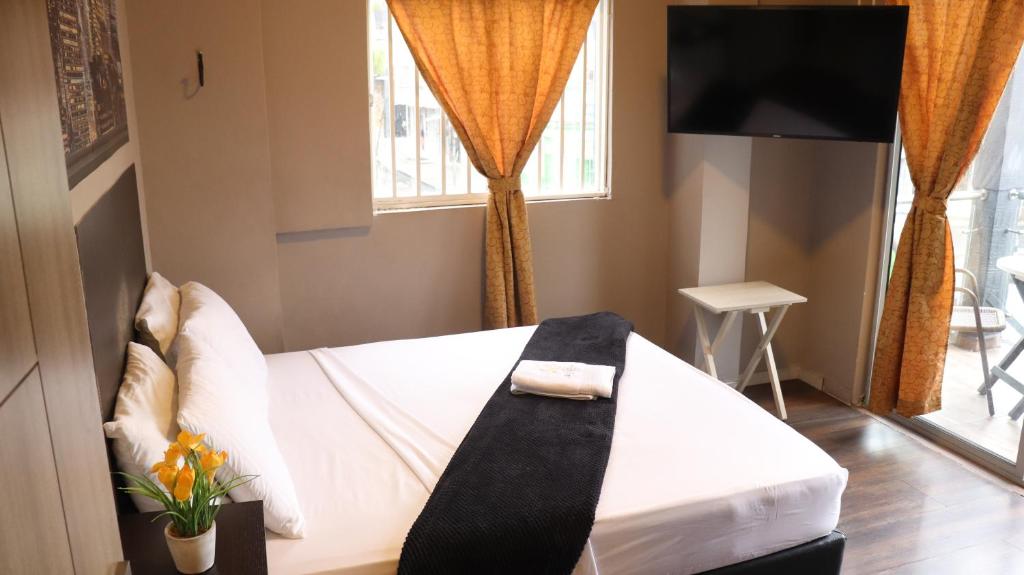 Postel nebo postele na pokoji v ubytování Hotel Simón Plaza