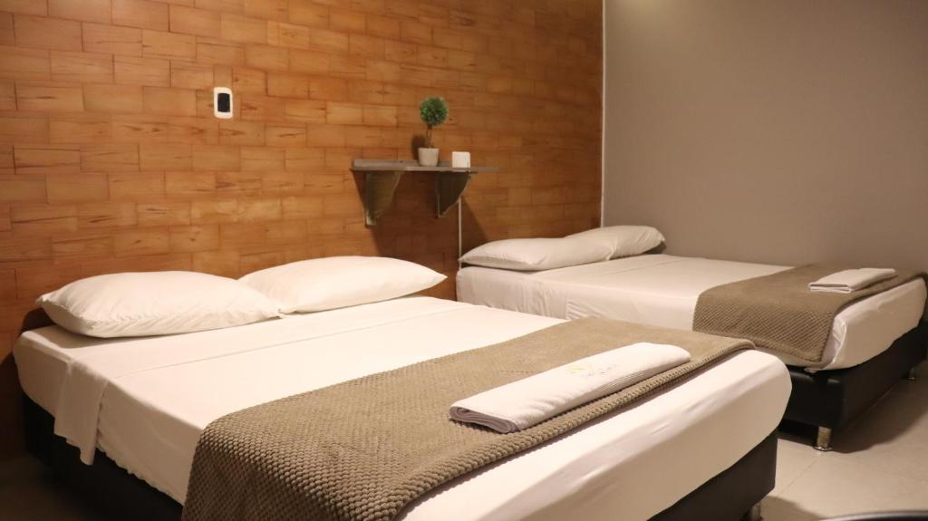 Postel nebo postele na pokoji v ubytování Hotel Simón Plaza