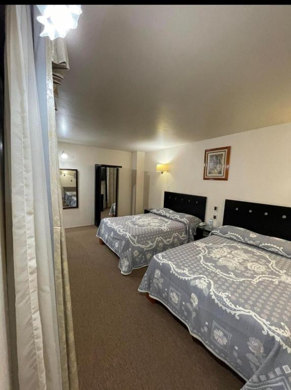 Postel nebo postele na pokoji v ubytování Hotel Novo