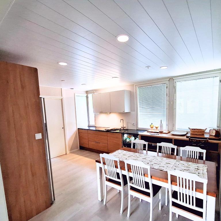 a kitchen with a table and chairs in a room at Villa Repo in Rovaniemi