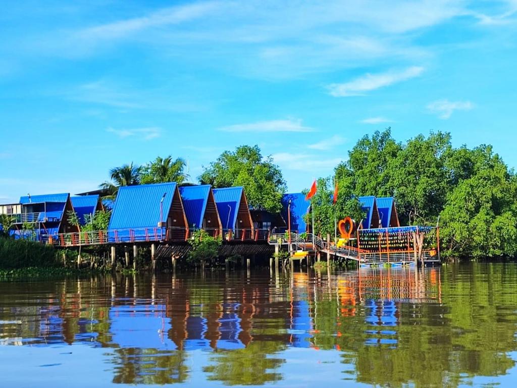 a train on a bridge over the water at Cồn Phụng Retreats Mekong - Nature Island with Free Boat Shuttle & Fishing in Ben Tre
