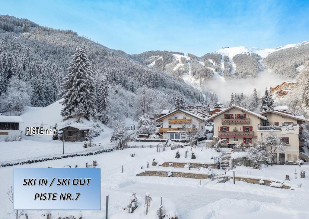 a ski resort in the mountains with snow on the ground at Chalet "Villa Marlene" in Zell am See