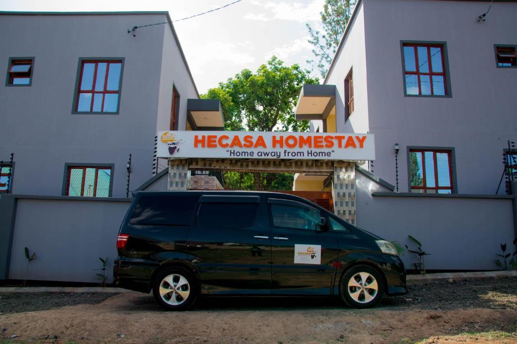a black van parked in front of a building at Hecasa Apartments in Arusha