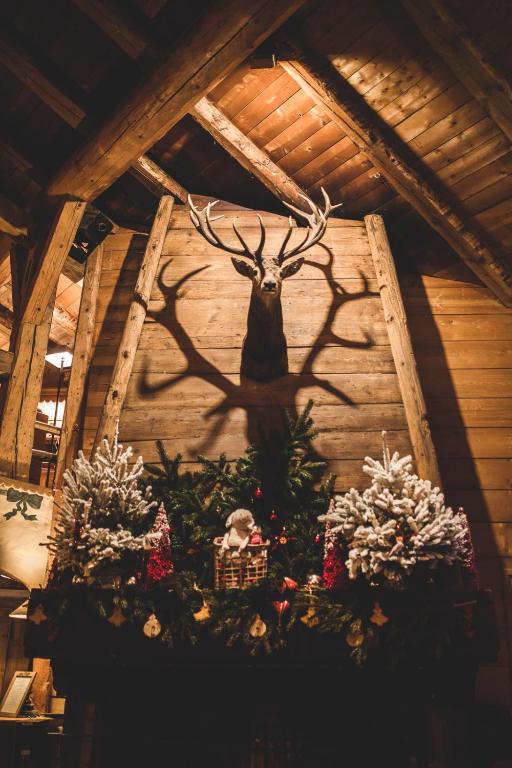 a wall with a deer head on it at Les Fermes de Marie in Megève