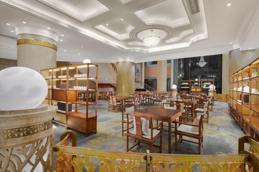 a dining room with wooden tables and chairs at Crowne Plaza Chengdu City Center by IHG in Chengdu