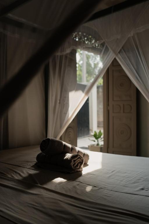 Postel nebo postele na pokoji v ubytování HAWARA CoLiving Midigama