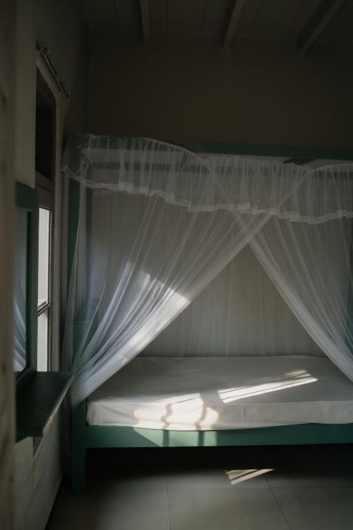 Postel nebo postele na pokoji v ubytování HAWARA CoLiving Midigama