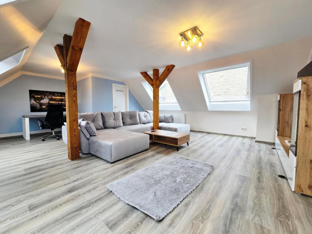 a living room with a couch and a table at Moritz Apartments - Apartment Pfarrgasse 11 - in Küllstedt