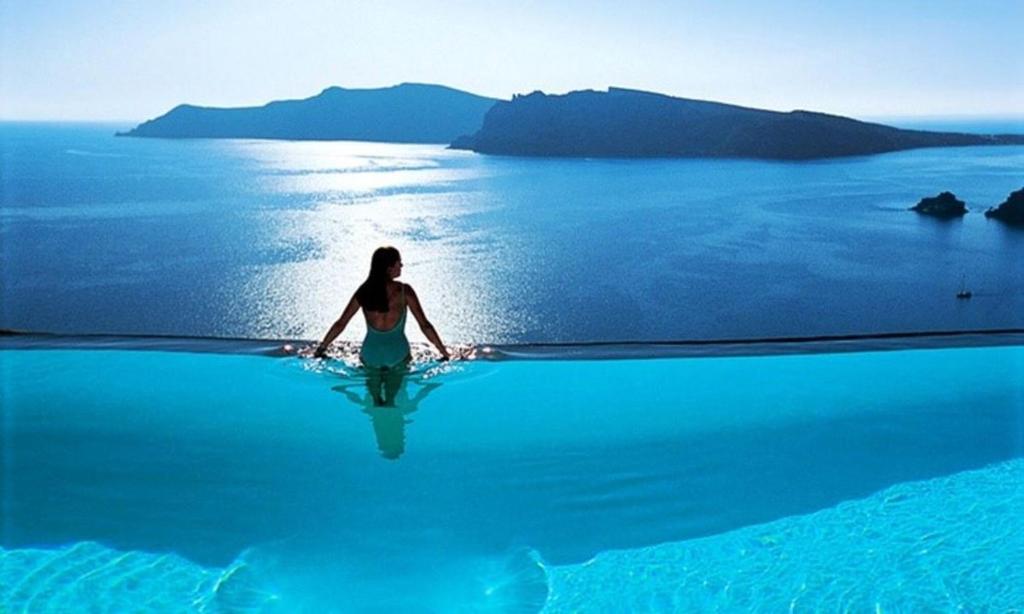 a woman standing in the water in the ocean at Nha Trang Superview Holidays in Nha Trang