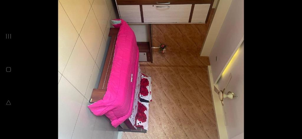 a pink umbrella hanging on a wall in a room at Flat in Visakhapatnam in Visakhapatnam