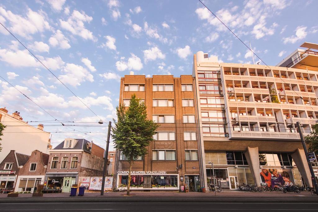 a building on a city street with a street at Conscious Hotel Vondelpark in Amsterdam