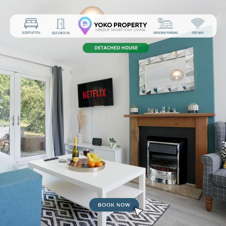 Hotel Detached House - Close to City Centre - Free Parking, Fast Wifi, Private Garden and Smart TV with Netflix by Yoko Property, a living room with a white table and a fireplace at Detached House - Close to City Centre - Free Parking, Fast Wifi, Private Garden and Smart TV with Netflix by Yoko Property in Milton Keynes