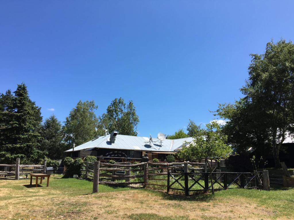 a barn with a roof on top of a fence at Crackenback Farm Guesthouse in Crackenback