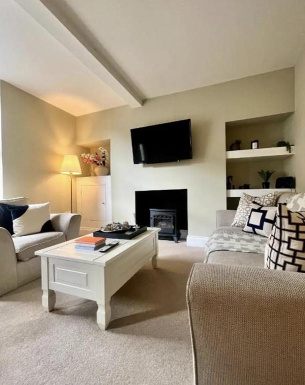 a living room with a couch and a coffee table at Queens Cottage in Skipton