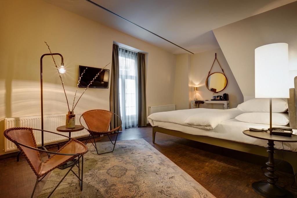 Postel nebo postele na pokoji v ubytování Hotel V Nesplein
