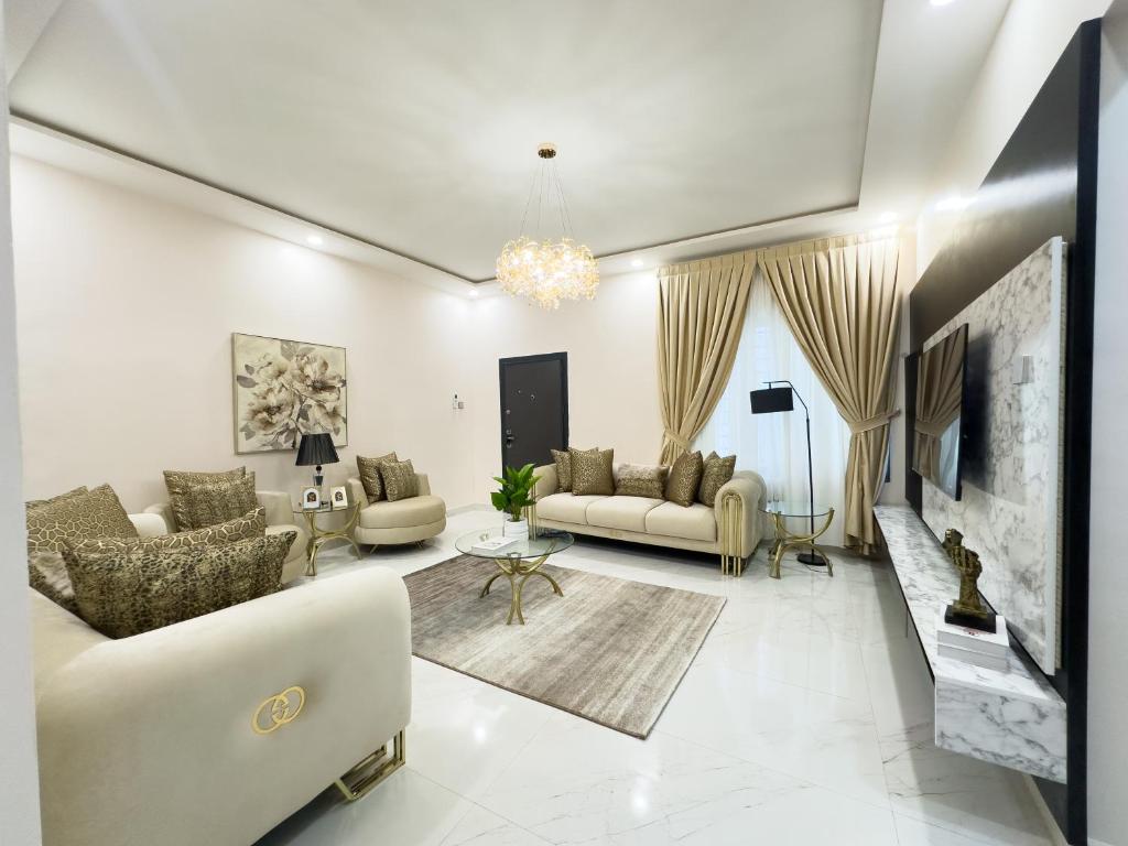 a living room with two couches and a tv at Teflon suites Kumasi in Kumasi