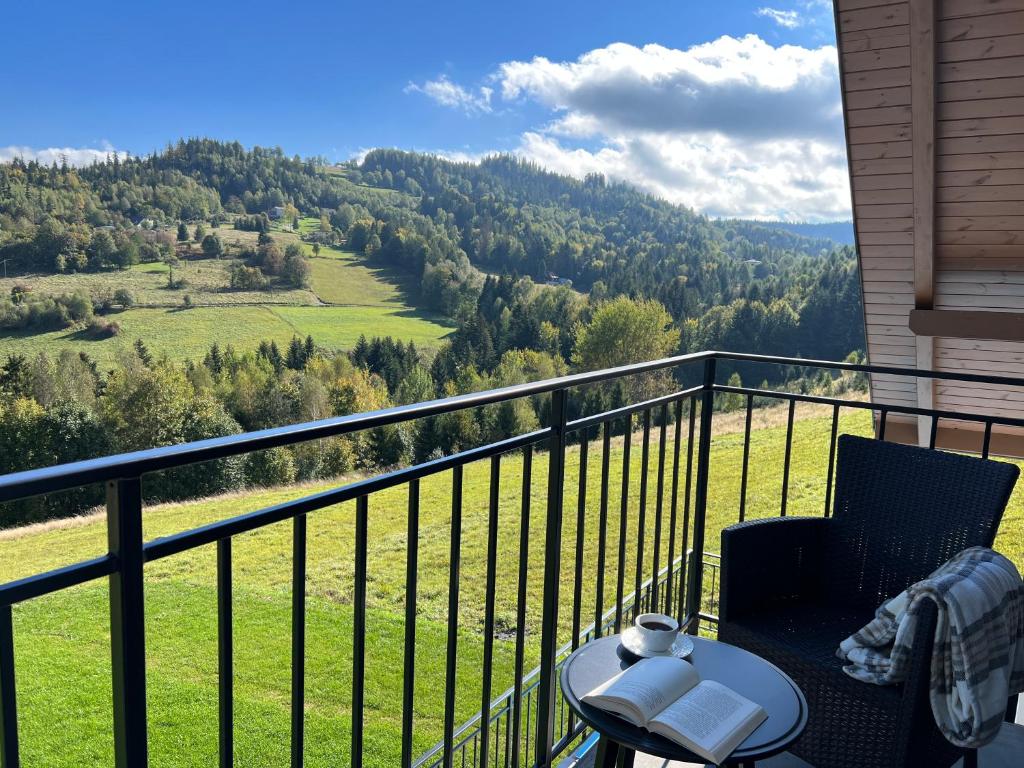 a balcony with a view of a green field at Apartamenty Spacerowa 33 in Wisła