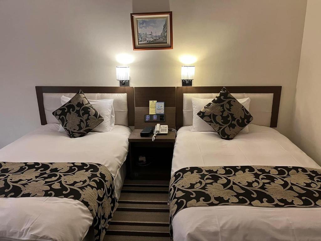 Postel nebo postele na pokoji v ubytování Hotel River Kinmen
