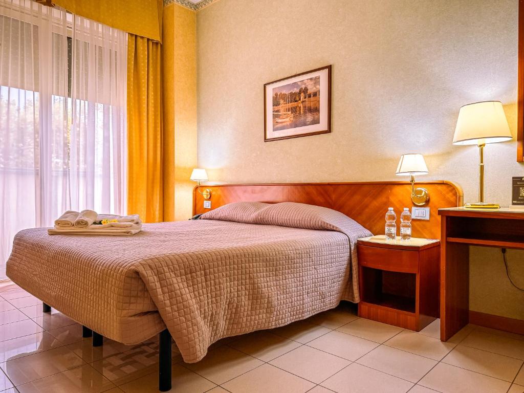 Postel nebo postele na pokoji v ubytování Hotel Remin Plaza