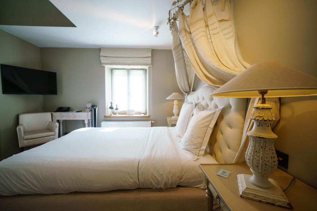 Postel nebo postele na pokoji v ubytování Hotel Saint-Amour