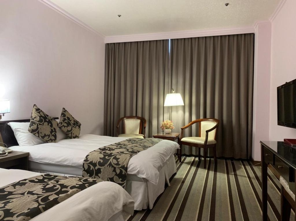 Postel nebo postele na pokoji v ubytování Hotel River Kinmen